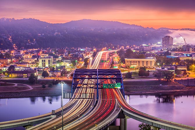 A long exposer shot of a bridge with traffic crossing it in West Virginia into and out of the main part of the capital of the state