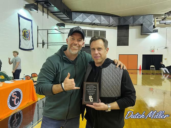 Dutch Miller Kia employee presenting an award