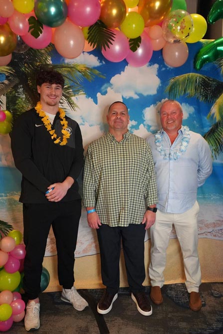 3 men attending a Hawaiian themed charity event.